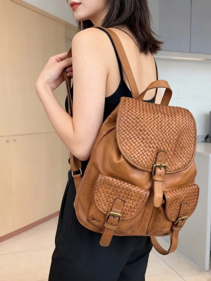 Basket-weave leather backpack with twin front pockets and buckle flap